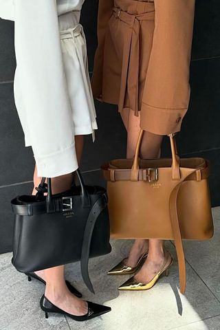 Threadsstyling two woman holding prada buckle bags